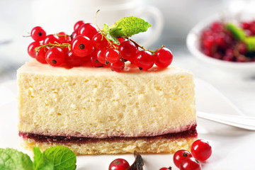 Delicious cheesecake with berries on table close up