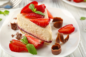Delicious cheesecake with berries on table close up