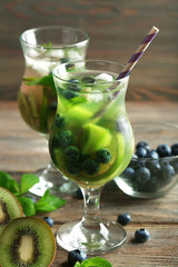 Kiwi and Blueberry cocktails on wooden background