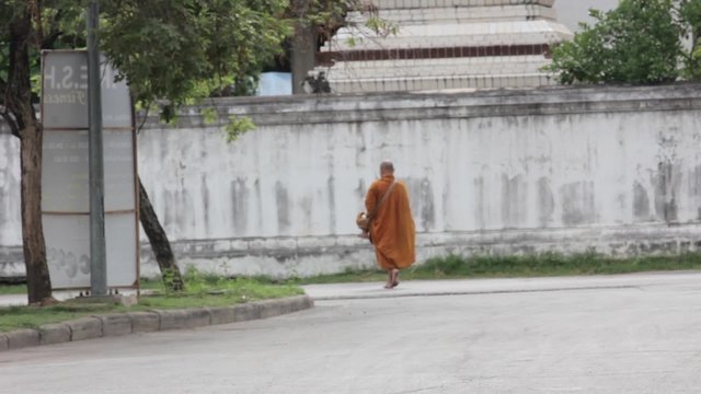 Buddhism Monk walking on the road in morning.