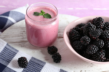 Delicious berry smoothie with blackberries on table close up