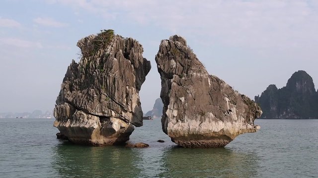 Famous rock formations often referred to as the Kissing Rocks in Halong Bay, Vietnam.