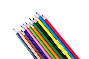 Colored pencils and a sheet of paper on the table