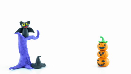 Halloween pumpkin made of clay over white background