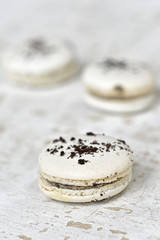 White macarons on wood plate