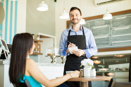 Handsome waiter doing his job