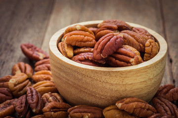 Pecan nuts in wooden bowl
