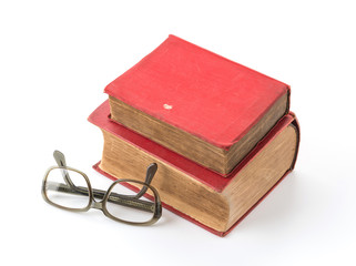 old book with glasses on white background