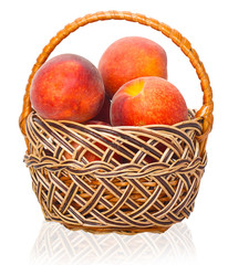 Ripe peaches in a wicker basket