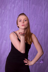 Fototapeta premium Young woman in black sends a kiss