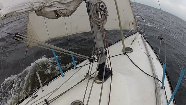 The yacht floats by the storming sea
