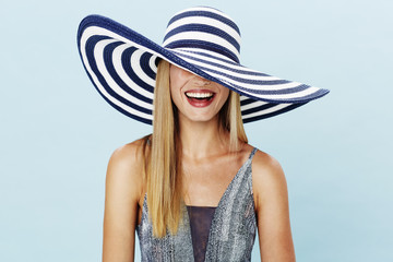 Laughing blond woman in summer hat