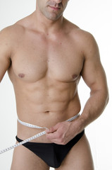 Fototapeta premium Hansome young man with measuring tape