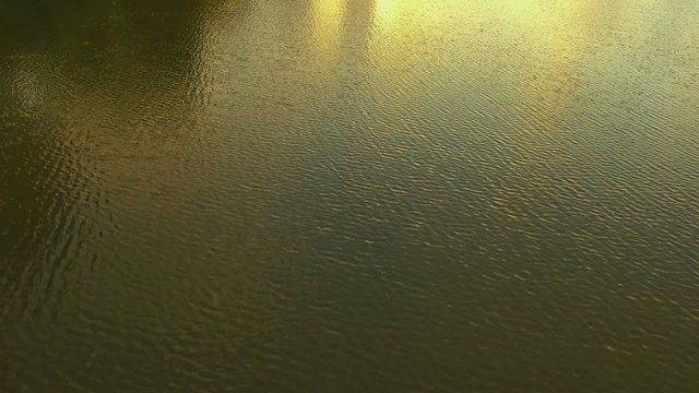 Aerial Shooting of the reflection in the water, a wonderful reflection of the sunset in the lake.