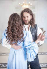Beautiful couple woman and man in medieval clothes