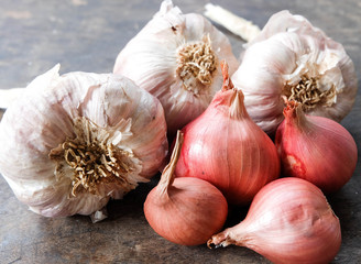 Garlic and onion on the wooden background