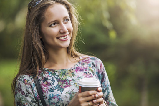 Beautiful Woman Model With Take-away Coffee In The Park