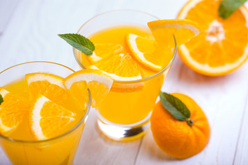 orange alcohol cocktail on a wooden table.