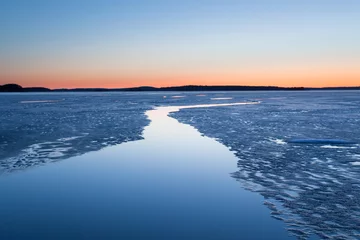 Foto op Canvas Serene frozen lake scape at twilight © Juhku