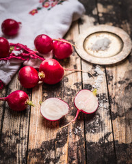 radish half with salt on rustic wooden background