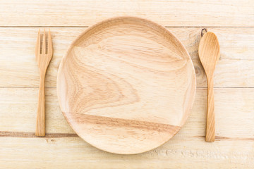 Empty wooden plate and spoons, forks.