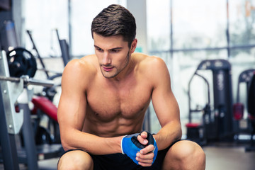 Man resting on the bench at gym