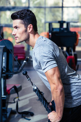 Fototapeta na wymiar Man workout in fitness gym