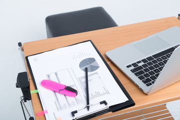 workplace with laptop and papers