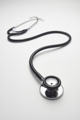 Black stethoscope on white background