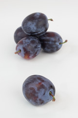 Closeup of ripe plums isolated on white.