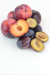Closeup of ripe plums isolated on white.