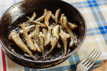 Roasted fresh river fish on cast iron pan