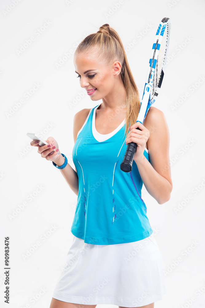 Wall mural Happy female tennis player using smartphone