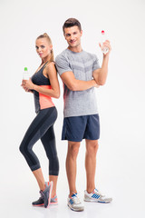 Couple standing with bottle of water