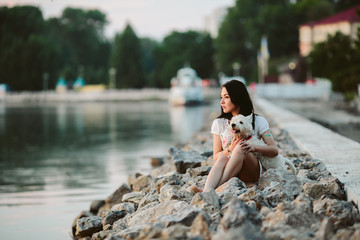 Fototapeta premium girl with a dog on the promenade