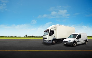 Fototapeta na wymiar White Delivery Van and Truck on the Road
