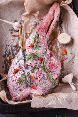 Raw leg of lamb with spices and rosemary.selective focus