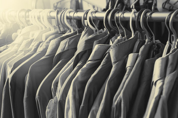 Clothes hang on a shelf in a designer clothes store