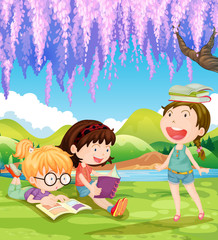 Obraz na płótnie Canvas Children reading books under the tree
