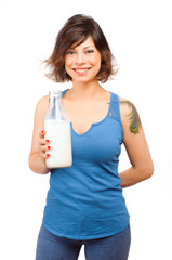 Real Caucasian young woman drinking milk from a bottle