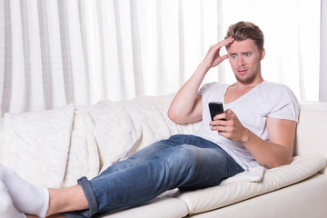 young man is scared about message on smartphone