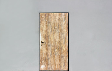 Background of a gray wall with closed wooden door