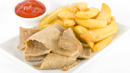 Donner Meat & Chips - Spicy lamb kebab slices served with fries and chilli sauce on a white background.
