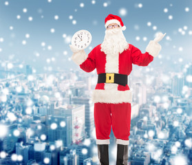 man in costume of santa claus with clock