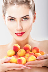 Beautiful woman holding a juicy apricots. Perfect skin. Professi