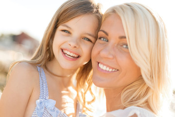 happy mother and child girl outdoors