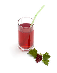 tall glass of juice and nearby branch of red currant