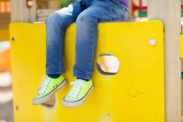 close up of boy legs on children playground