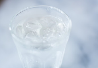 Soft focus. Glass of pure fresh water  with ice , focus on ice
