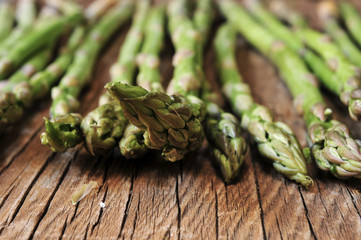 raw asparagus on a rustic wooden table, filtered